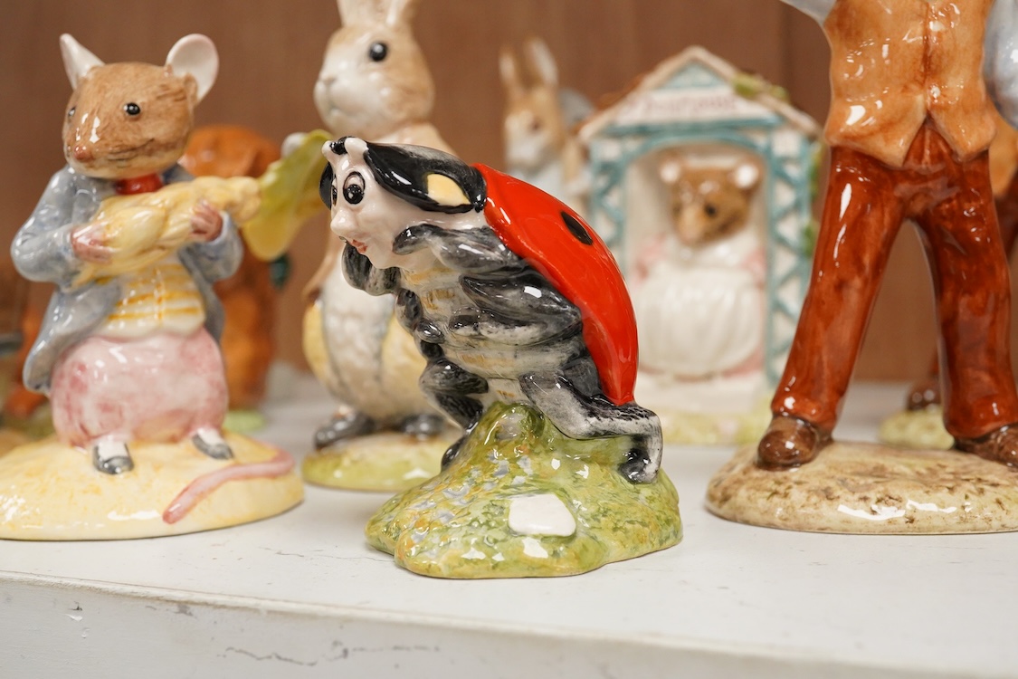 A collection of eighteen mixed Royal Doulton and Royal Albert figures of Beatrix Potter characters, largest 13cm high